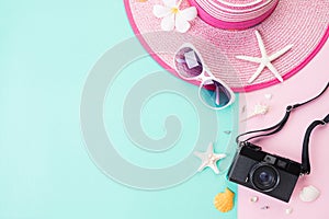 Top view of Beach accessories Picture Frame, sunglasses, starfish beach hat and sea shell on bright pastel green background for