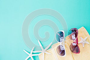 Top view of Beach accessories starfish beach hat and sea shell on bright pastel green background for summer holiday and vacation