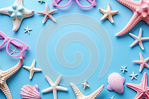 Top view of beach sunglasses with seashell and starfish on a blue summer background