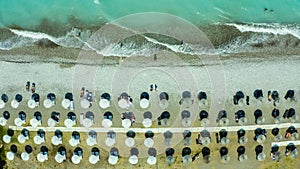 Top view of beach with tourists, sunbeds and umbrellas. Sea travel destination