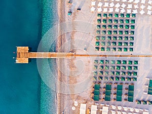 Top view of the beach with umbrellas and sunbeds on the sand