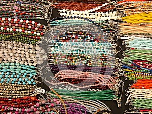 Top view of beaded necklaces displayed in the market