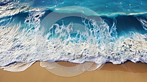 Top view of beautiful blue sea waves and sandy beach with rocks