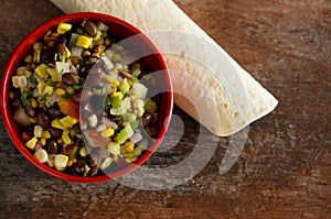 Top View of Beautiful, Colorful and Delicious Mexican Salad in a Red Bowl with Tortillas