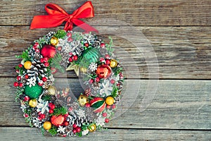 Top view Beautiful hand made traditional bright Christmas wreath decorated with pine cones, spruce branches,berries, balls, stars