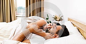 Top view of beautiful young couple sleeping together and hugging in bed at home.