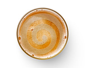 Top view of beer bubbles in glass cup on white background