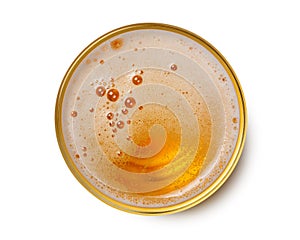 Top view of beer bubbles in glass cup on white background