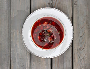 Top view on beetroot soup on old wooden table