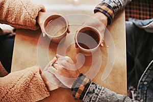 Top view of beloved couple with hot drink