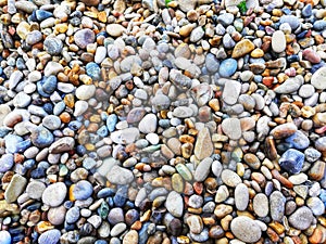 Top view of big and small pebble stones on the seashore