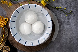 Top view of big tangyuan yuanxiao in a bowl on gray background for lunar new year food photo