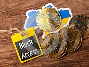 Top view bitcoins,ukraine flag and wooden board with text block access