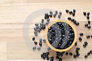 Top view of black beans in a bowl on wooder background, Healthy eating concept