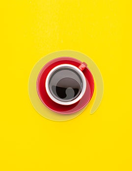 Top view black coffee or Americano in red cup isolated on yellow