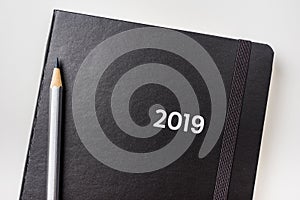 Top view of black notebook with word 2019