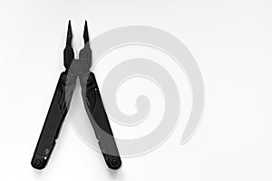 Top view of black pliers of  multi tool   multitool  on white backround with empty space. Business and craft concept