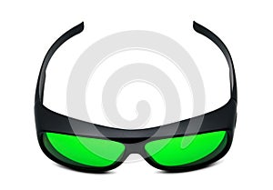 Top-view of black sport sunglasses with green lenses or night vision glasses against white isolated background for product design