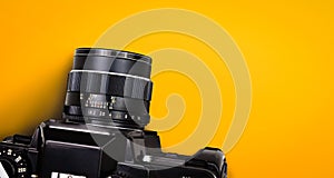 Top view of black vintage film camera isolated on yellow background included clipping patht