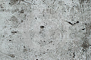 Top view of black, white, gray grunge textured rough stone background with cracks, scratches and stains.