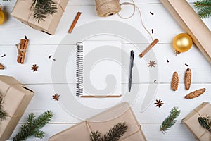 Top view of blank notebook for template design on white wooden background with xmas decorations, copy space. Christmas background photo