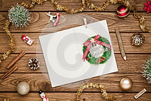 Top view of blank notebook on wood  background with xmas decorations. Mockup Christmas background with notebook for wish list or