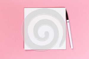 Top view of blank open notebook on pink background, concept of education or new workplace