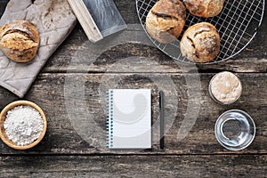 Top view of blank recipe notepad with black marker next to bread buns