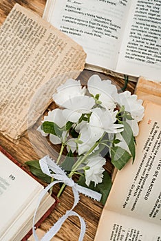 Top view of blank shabby old book with dried wild flowers on wooden table