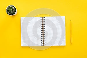 Top view of blank spiral notebook and pen