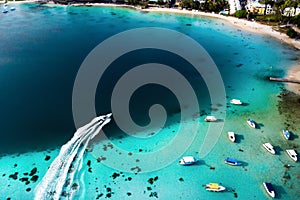 Top view of the Blue Bay lagoon of Mauritius. A boat floats on a turquoise lagoon