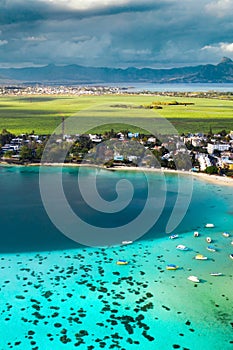 Top view of the Blue Bay lagoon of Mauritius. A boat floats on a turquoise lagoon