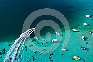 Top view of the Blue Bay lagoon of Mauritius. A boat floats on a turquoise lagoon