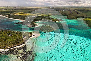 Top view of the Blue Bay lagoon of Mauritius. A boat floats on a turquoise lagoon