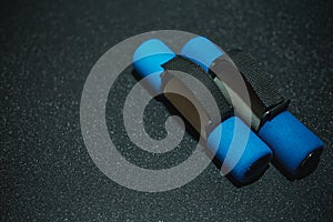 Top view of blue - black dumbbells on a black background. Workout equipment for training at home top view. Fitness