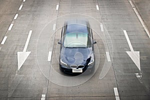 Top view blue car Racing and white arrow sign on the road