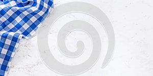 Top of view blue checkered tablecloth on white marble table