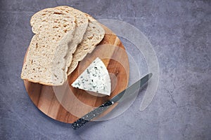 top view of blue cheese ,and slice of brown bread on table