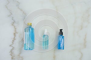 Top view of Blue Ethyl alcohol in different packages , spray bottle, plastic bottle and gel bottle, for coronavirus protection  on