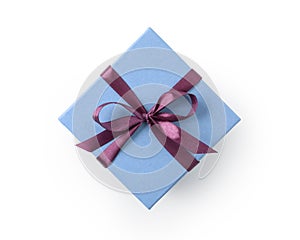 Top view of blue gift box with purple ribbon bow isolated on white background