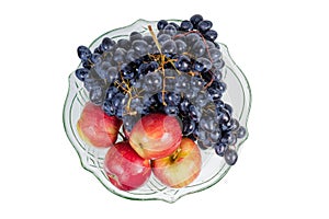 Top view of blue grapes and apples in fruits bowl