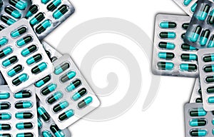 Top view of blue and green antibiotics capsule pills in blister packs isolated on white background with copy space. Antimicrobial