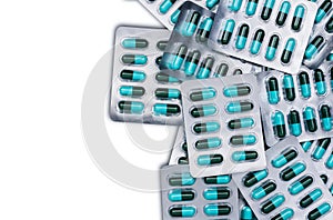 Top view of blue and green antibiotics capsule pills in blister packs isolated on white background with copy space. Antimicrobial