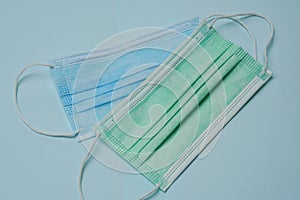 Top view blue and green medical face mask for Covid-19 prevention in health crisis