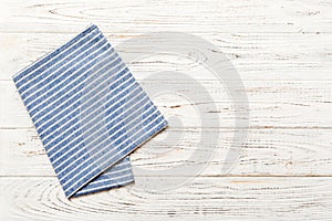 top view with blue kitchen napkin isolated on table background. Folded cloth for mockup with copy space, Flat lay