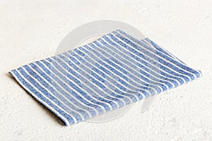 top view with blue kitchen napkin isolated on table background. Folded cloth for mockup with copy space, Flat lay