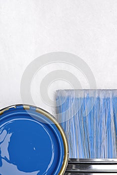 Top view of blue paint can with brush