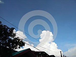 Top view of blue sky and white cloud over the roof