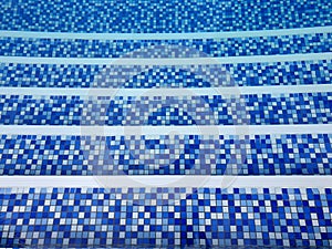Top view of blue swimming pool stairs.