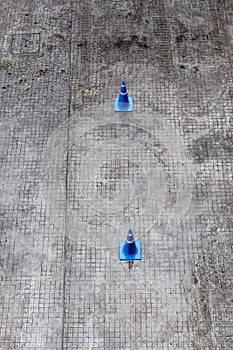 Top view of blue traffic cones on asphalt road for traffic lanes